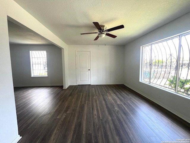 empty room with a textured ceiling, wood-type flooring, and ceiling fan