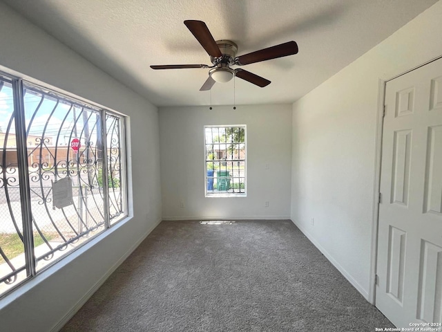 empty room with carpet floors and ceiling fan