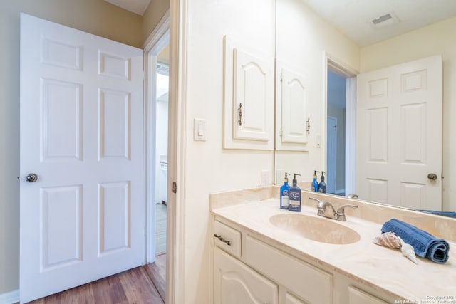 bathroom featuring vanity and hardwood / wood-style floors