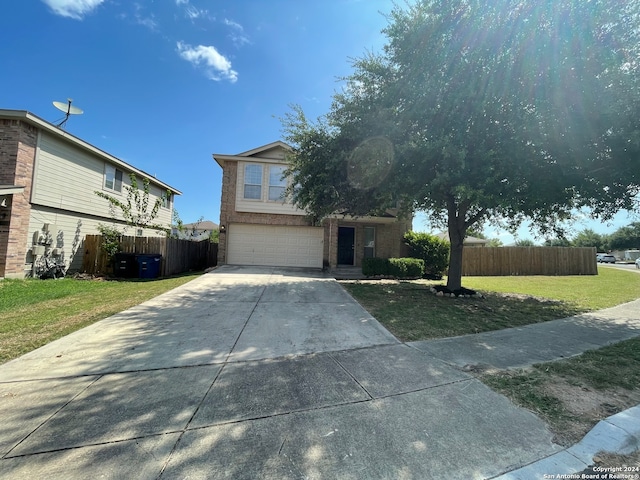 view of front of house featuring a garage and a front lawn