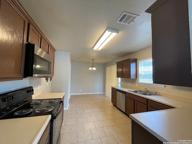 kitchen featuring light tile patterned floors, an inviting chandelier, hanging light fixtures, appliances with stainless steel finishes, and sink