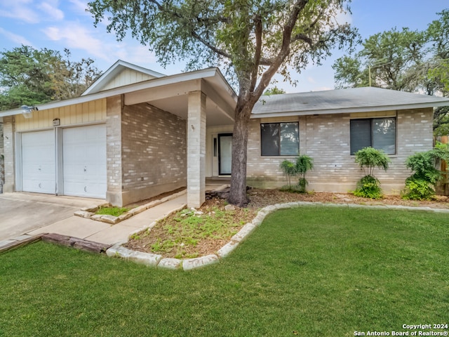 ranch-style home featuring a garage and a front lawn