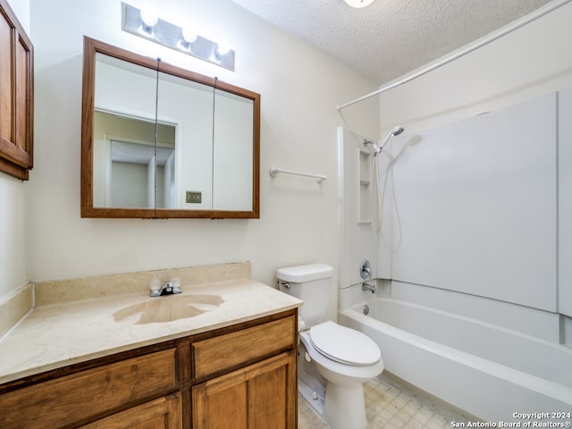 full bathroom featuring a textured ceiling, tile patterned floors, toilet, shower / tub combination, and vanity