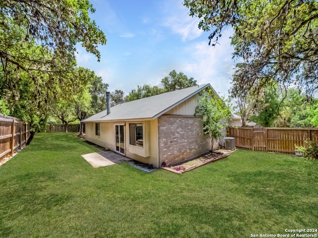 rear view of house with a yard