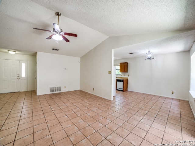 unfurnished living room with a textured ceiling, ceiling fan, vaulted ceiling, and light tile patterned floors