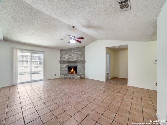 unfurnished living room with a fireplace, ceiling fan, vaulted ceiling, a textured ceiling, and light tile patterned floors