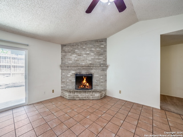 unfurnished living room featuring light tile patterned flooring, a fireplace, ceiling fan, and lofted ceiling