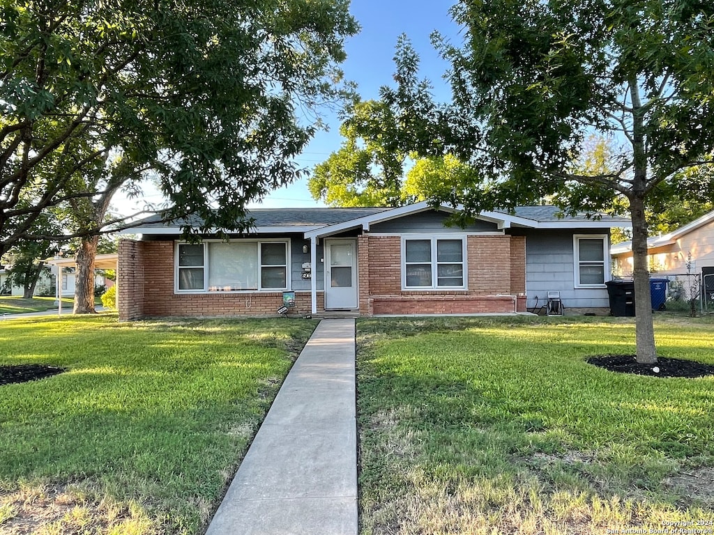 single story home featuring a front lawn