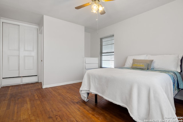 bedroom with a closet, hardwood / wood-style floors, and ceiling fan