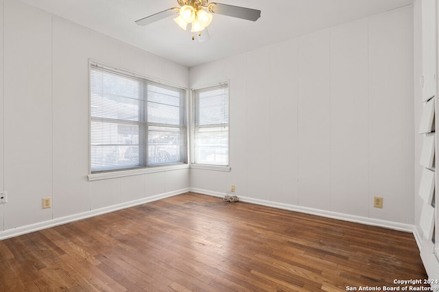 spare room with ceiling fan and dark hardwood / wood-style floors