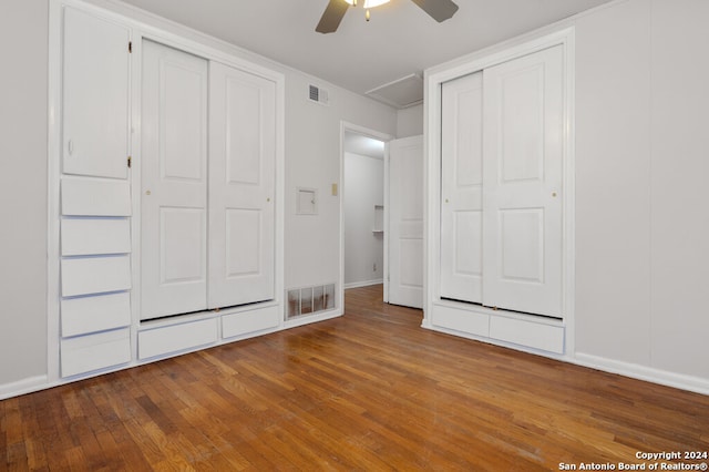 unfurnished bedroom with ceiling fan and wood-type flooring