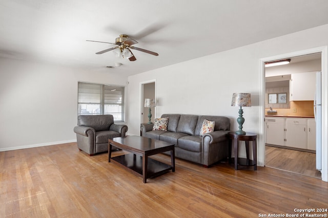 living room featuring light wood-type flooring and ceiling fan