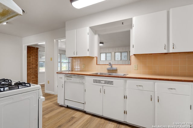 kitchen featuring decorative backsplash, white cabinetry, light hardwood / wood-style floors, sink, and white appliances