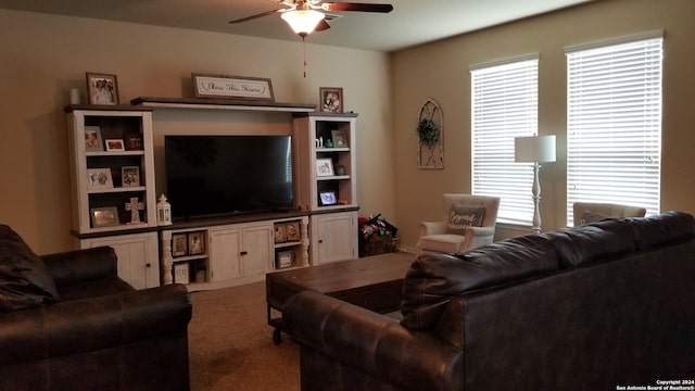 carpeted living room with ceiling fan