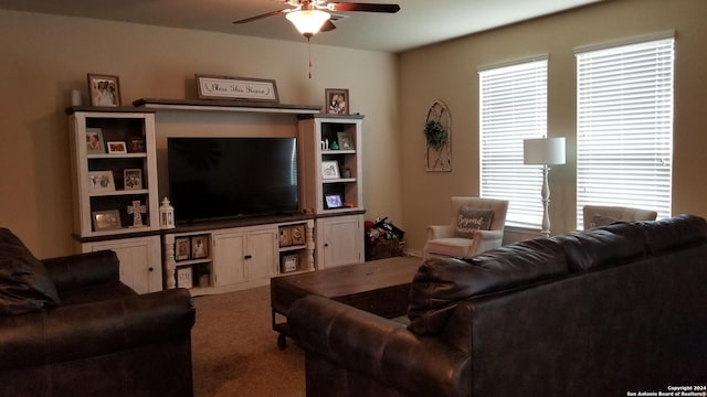 carpeted living area with ceiling fan