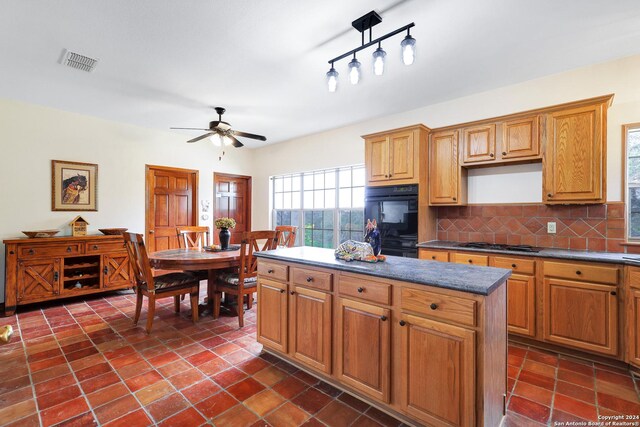 home office with tile patterned flooring, ceiling fan, and built in desk