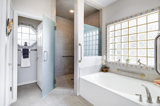 bathroom featuring shower with separate bathtub, tile patterned floors, and a wealth of natural light