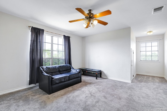 sitting room featuring carpet and ceiling fan