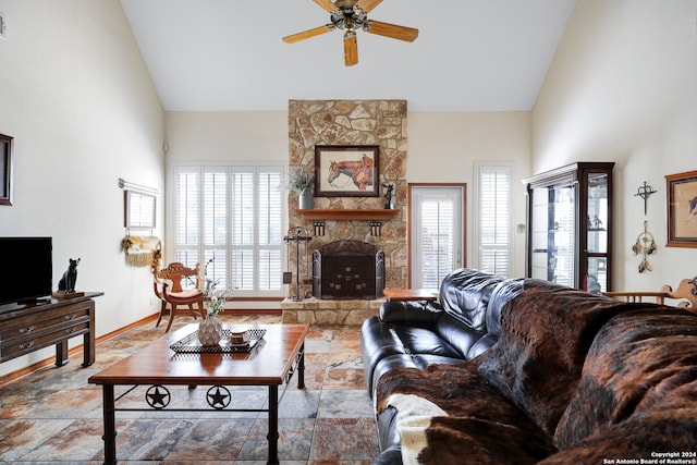 living room featuring high vaulted ceiling, a fireplace, ceiling fan, and a healthy amount of sunlight