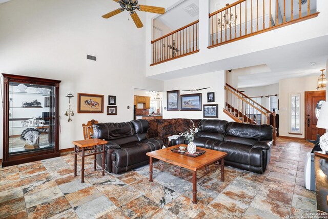 kitchen featuring dark tile patterned flooring, ceiling fan with notable chandelier, double oven, decorative backsplash, and decorative light fixtures