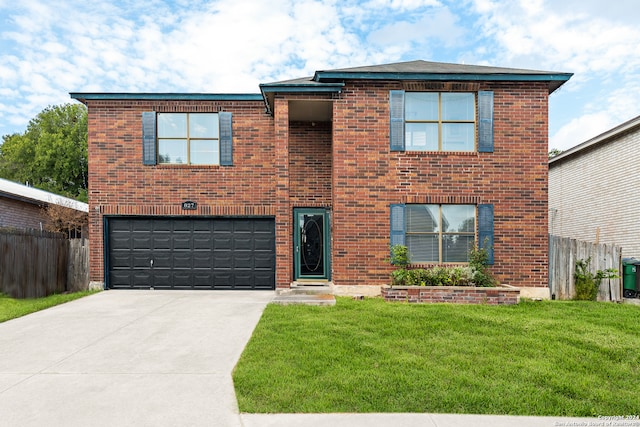 view of front facade with a garage and a front lawn