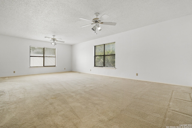 spare room with carpet, a textured ceiling, and ceiling fan