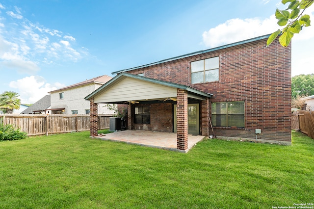 back of property featuring a patio, cooling unit, and a yard