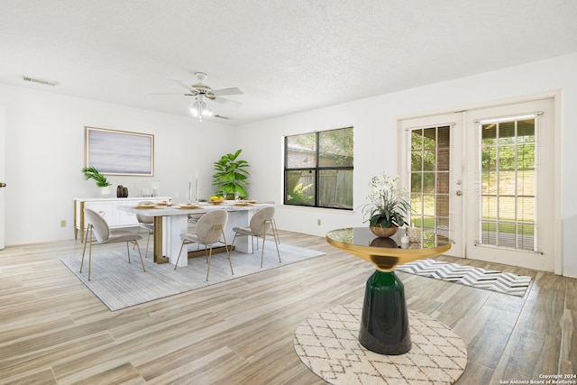 dining space with ceiling fan, light hardwood / wood-style flooring, and a healthy amount of sunlight