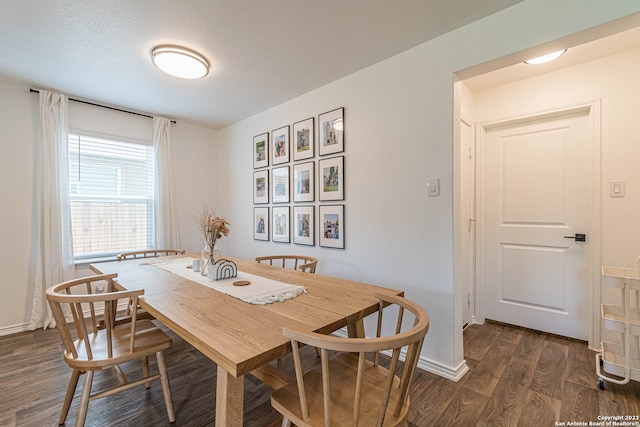 dining space with dark hardwood / wood-style flooring