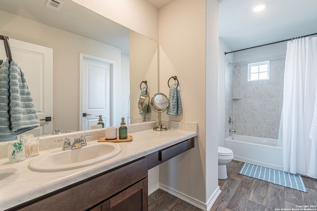 full bathroom with vanity, shower / bath combo, toilet, and hardwood / wood-style floors