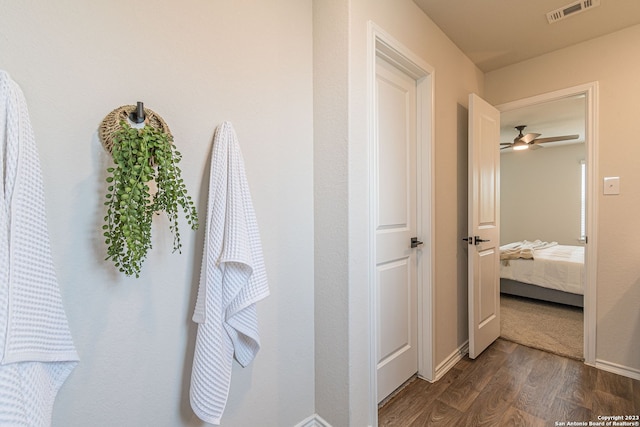 hallway with dark hardwood / wood-style flooring