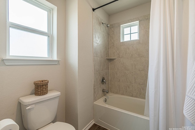 bathroom with shower / bath combo with shower curtain and toilet