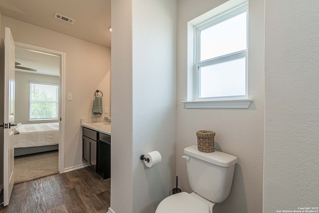 bathroom featuring hardwood / wood-style flooring, toilet, and vanity