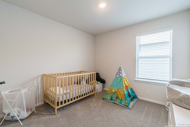 carpeted bedroom with a crib