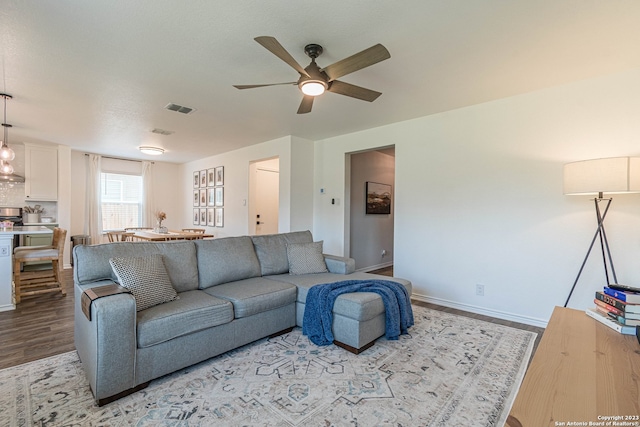 living room with light wood-type flooring and ceiling fan