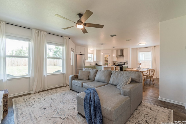 living room featuring sink, a healthy amount of sunlight, ceiling fan, and hardwood / wood-style floors