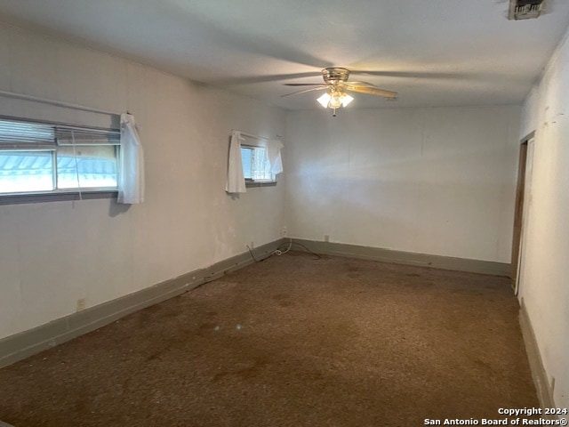 unfurnished room featuring ceiling fan, carpet floors, and plenty of natural light