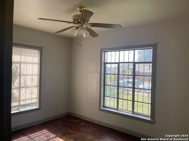 empty room featuring hardwood / wood-style flooring and ceiling fan