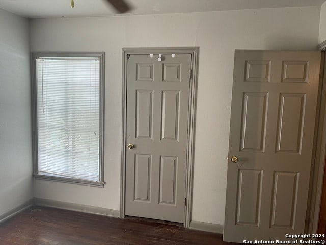 interior space featuring dark hardwood / wood-style flooring and ceiling fan