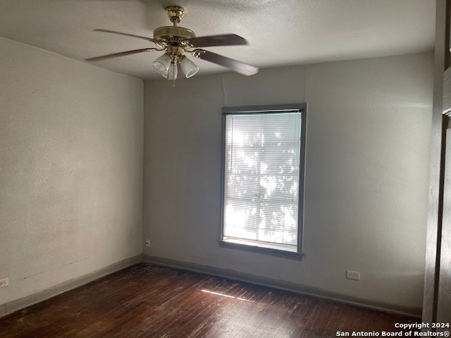 spare room featuring hardwood / wood-style flooring and ceiling fan