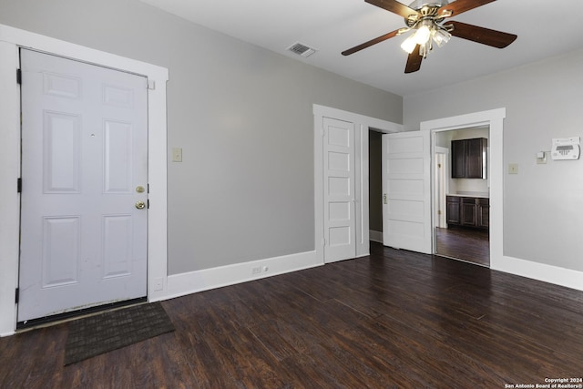 spare room with ceiling fan and dark hardwood / wood-style floors