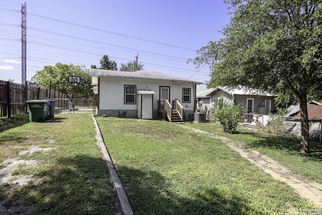 view of front of property featuring a front lawn and central air condition unit