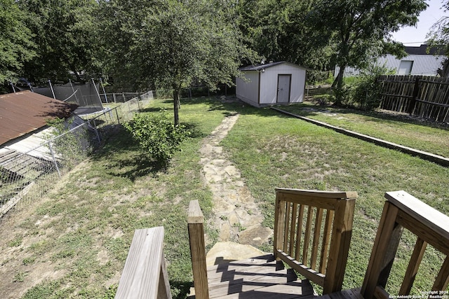 view of yard with a storage shed, a deck, and a trampoline