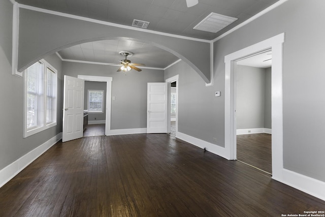 unfurnished living room with crown molding, dark wood-type flooring, and ceiling fan