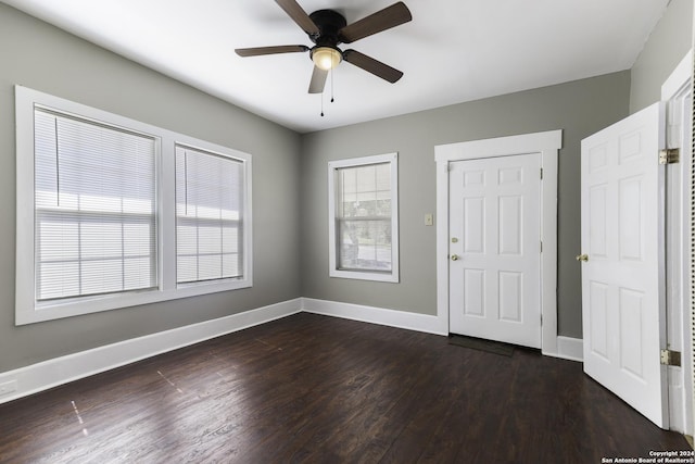 interior space with dark hardwood / wood-style flooring and ceiling fan