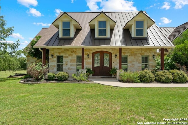 cape cod-style house featuring a front yard