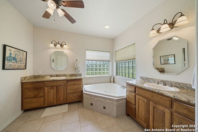 bathroom with a relaxing tiled tub, vanity, tile patterned flooring, and ceiling fan