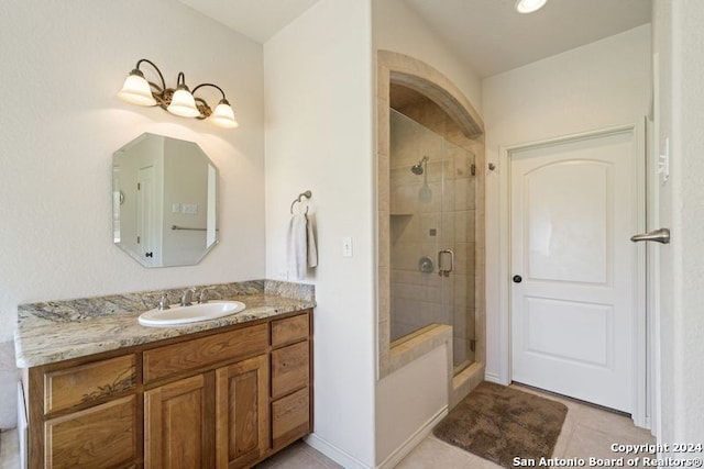 bathroom with vanity, tile patterned floors, and walk in shower