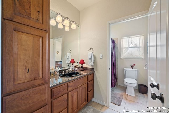 bathroom featuring vanity, tile patterned floors, and toilet