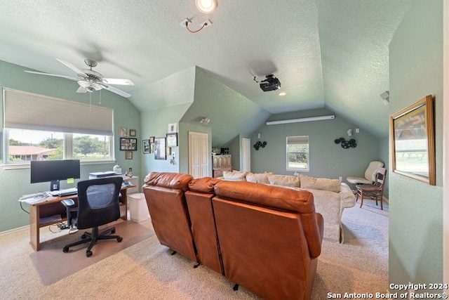 interior space featuring ceiling fan, light colored carpet, lofted ceiling, and a textured ceiling